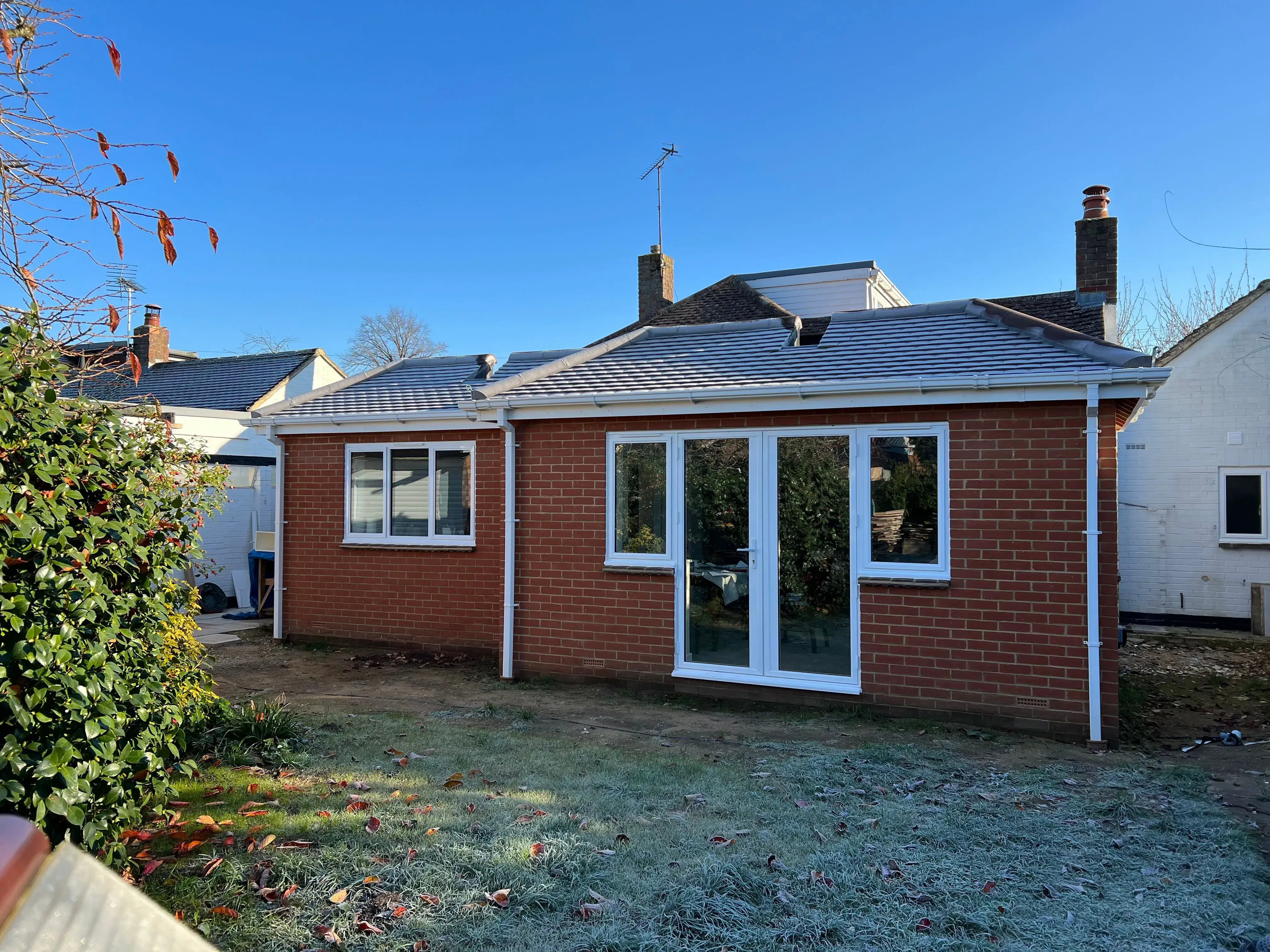 A small brick house with a sliding glass door.